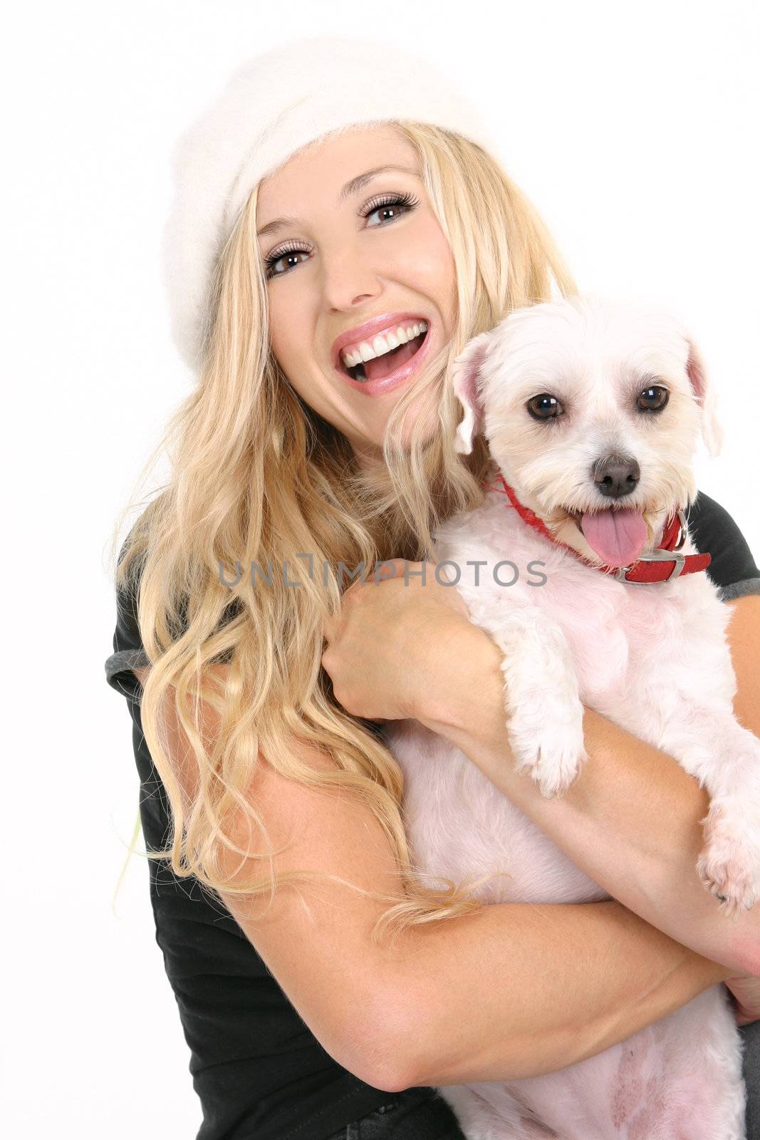 Laughing female holding a cute small white dog