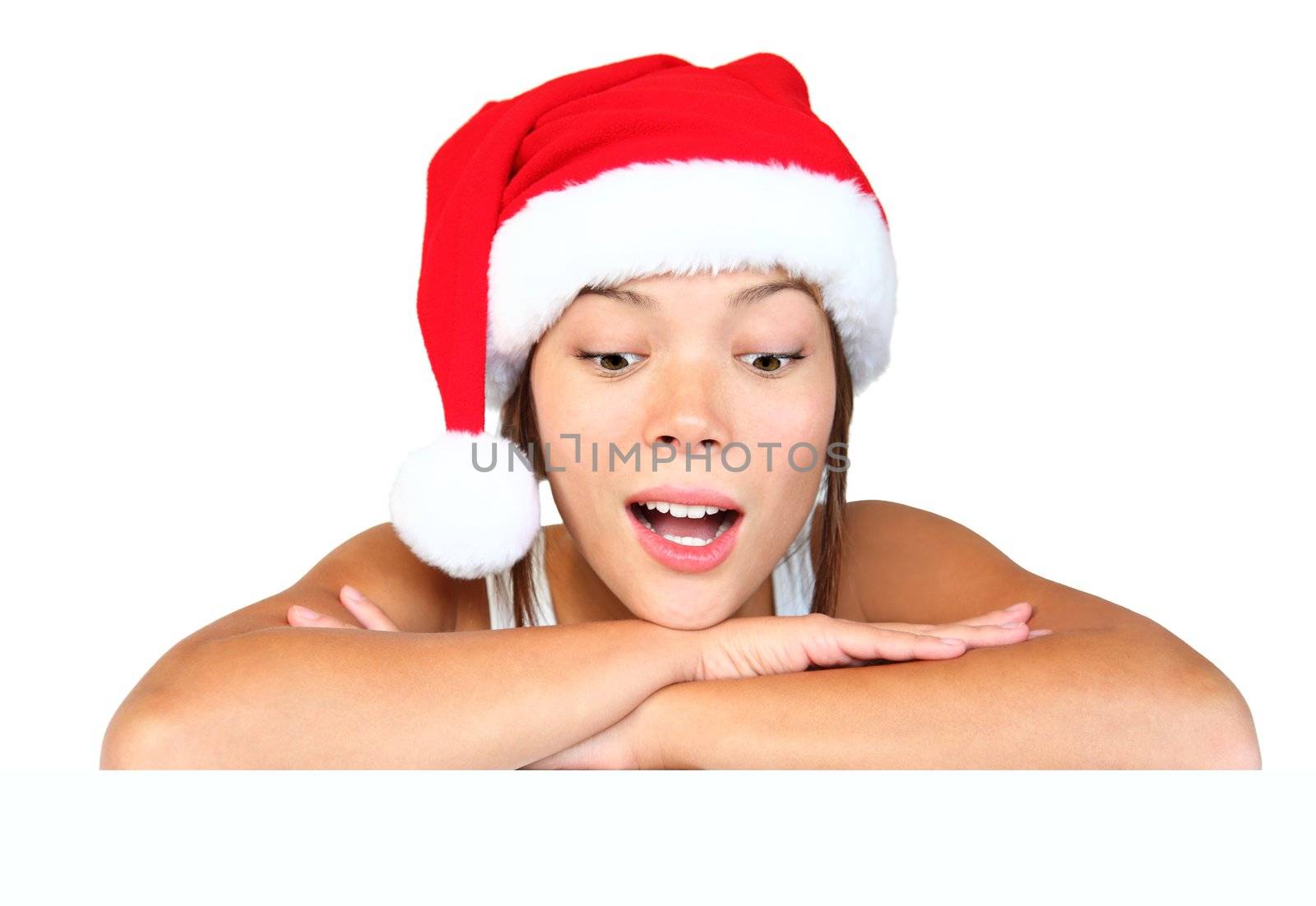 Christmas girl with sign. Very beautiful mixed race asian / caucasian woman with billboard looking surprised down at the sign. Isolated on white background.