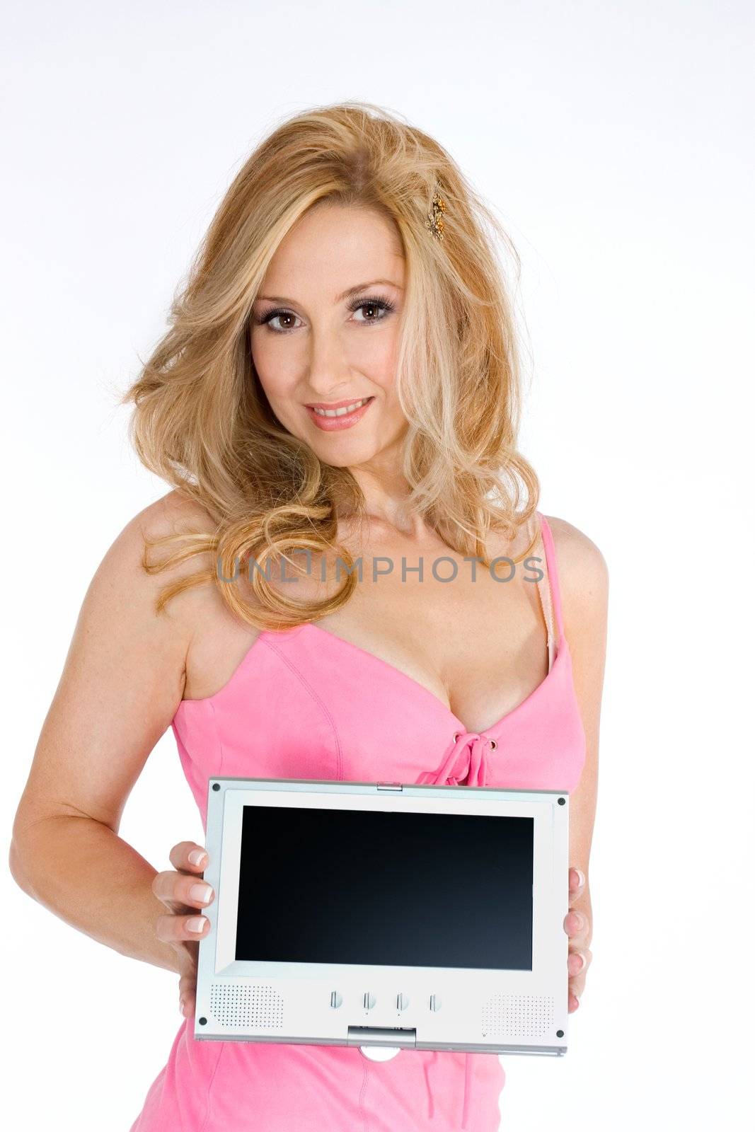 Woman in pink dress showcasing electronic equipment with blank lcd screen ready to add a message or picture..