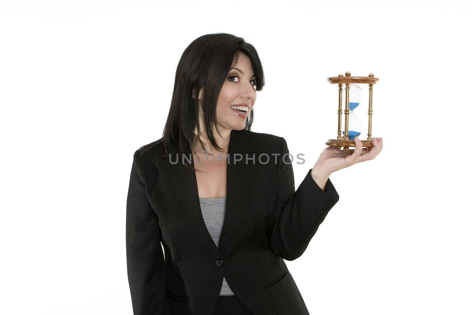 A businesswoman holding a traditional sand timer in her hand. You could change the sandtimer for another product.