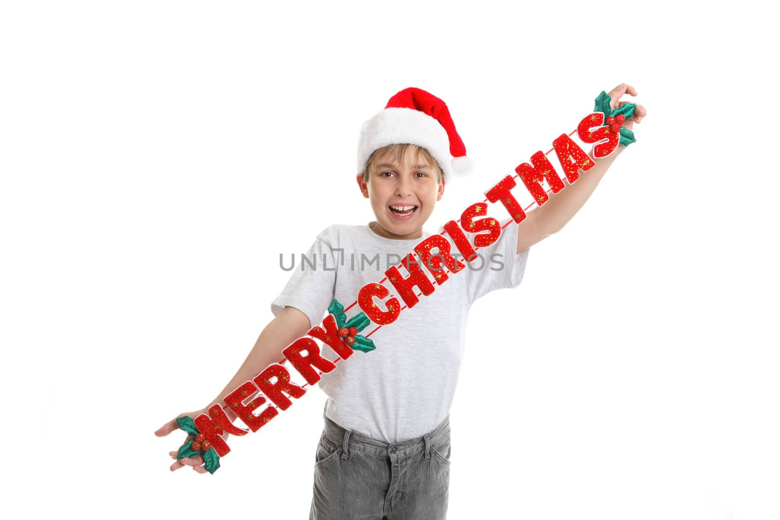 A child holding a fabric Christmas decoration,  that says Merry Christmas 