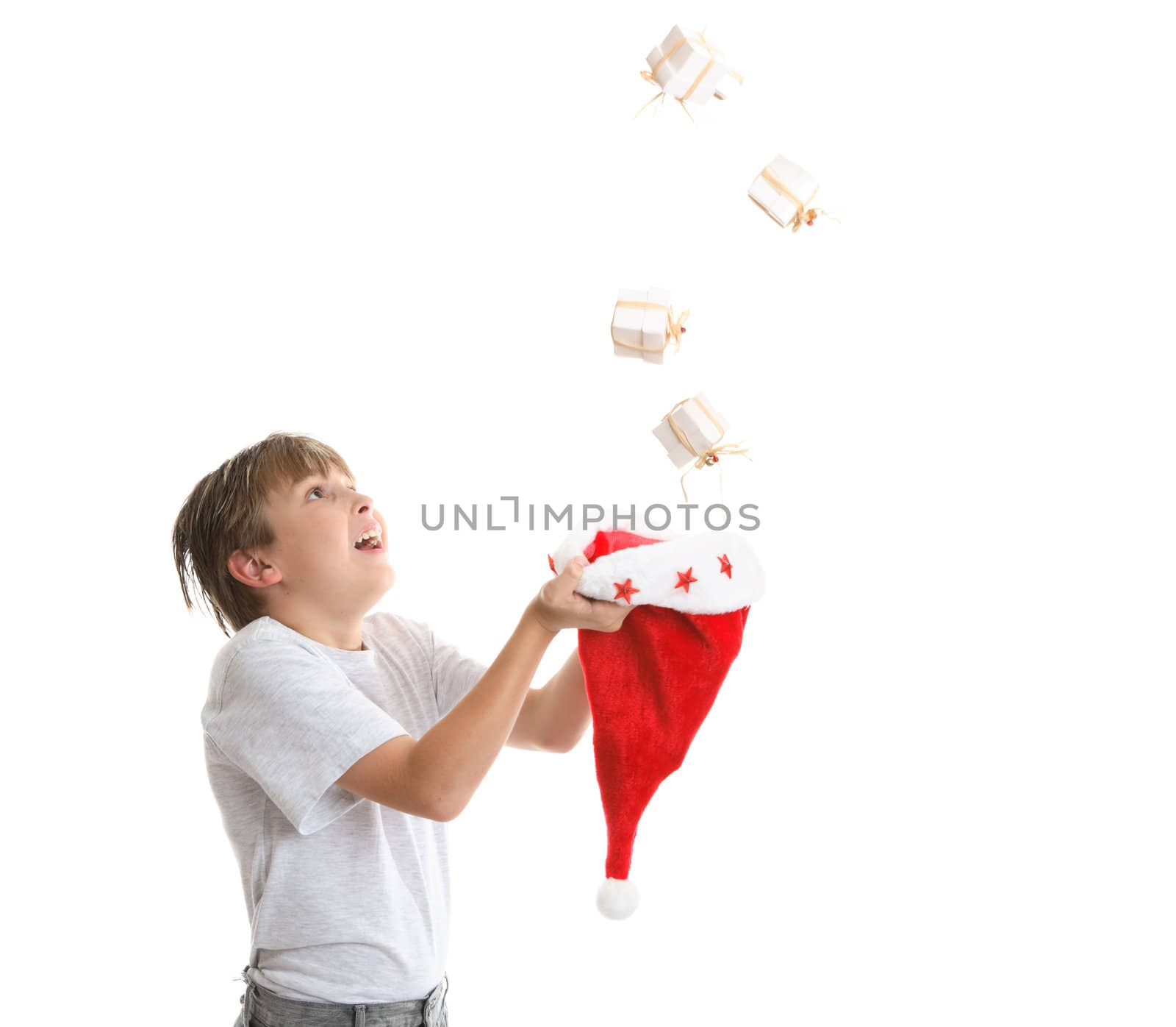 Boy looking up is catching falling Christmas presents 
