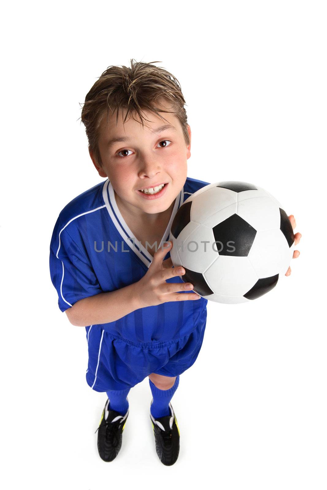 A boy ready for a game of soccer.