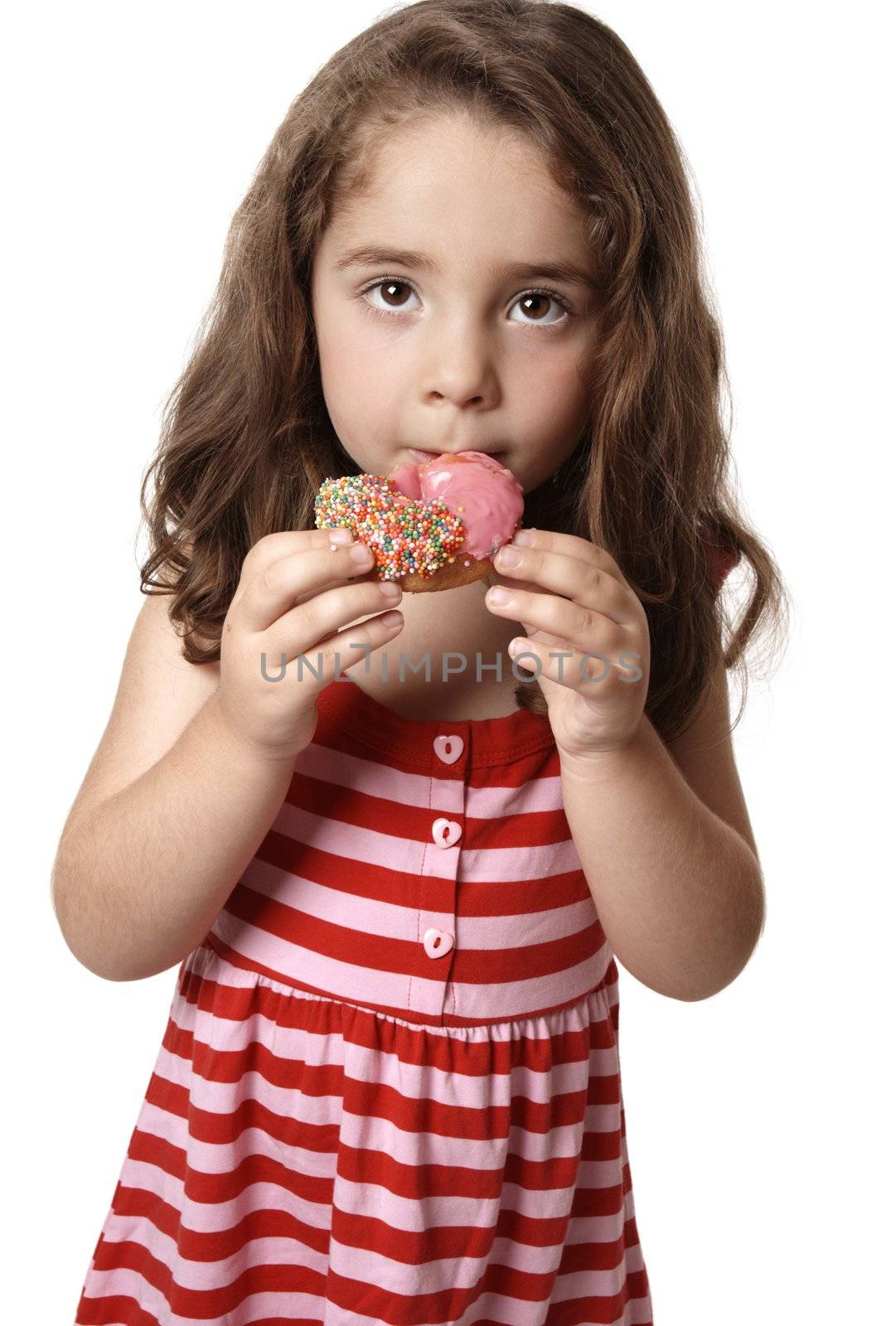 A child eating an unhealthy doughnut snack.