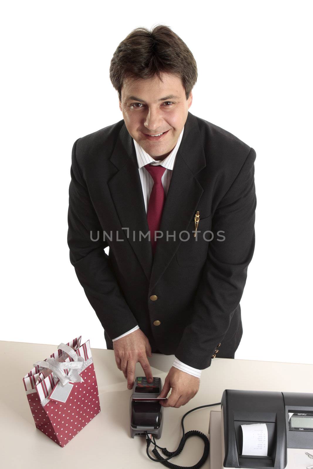 A man dressed in suit buying a birthday, Christmas or special occasion present using credit or debit card.