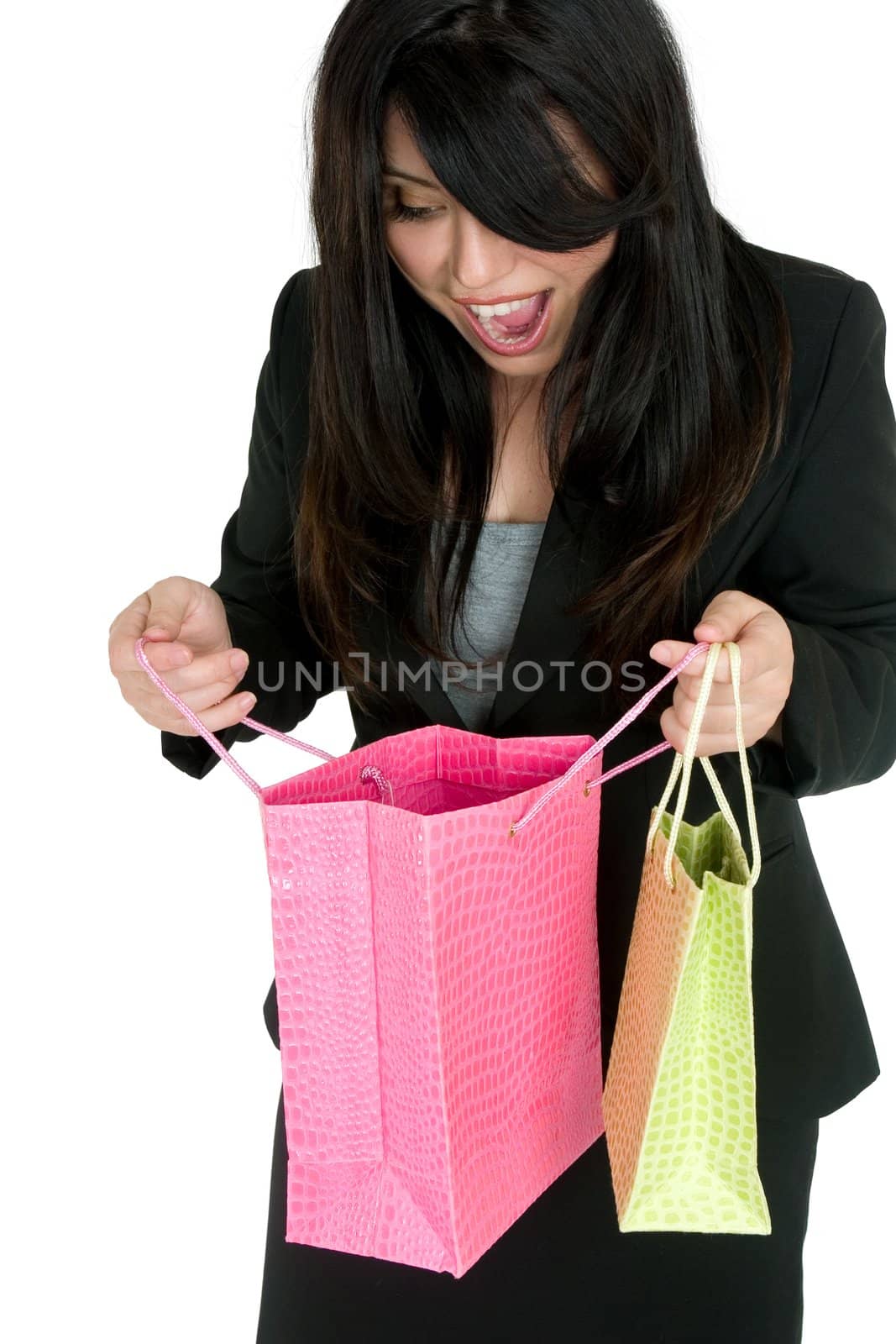 A delighted woman looking into some colourful gift bags