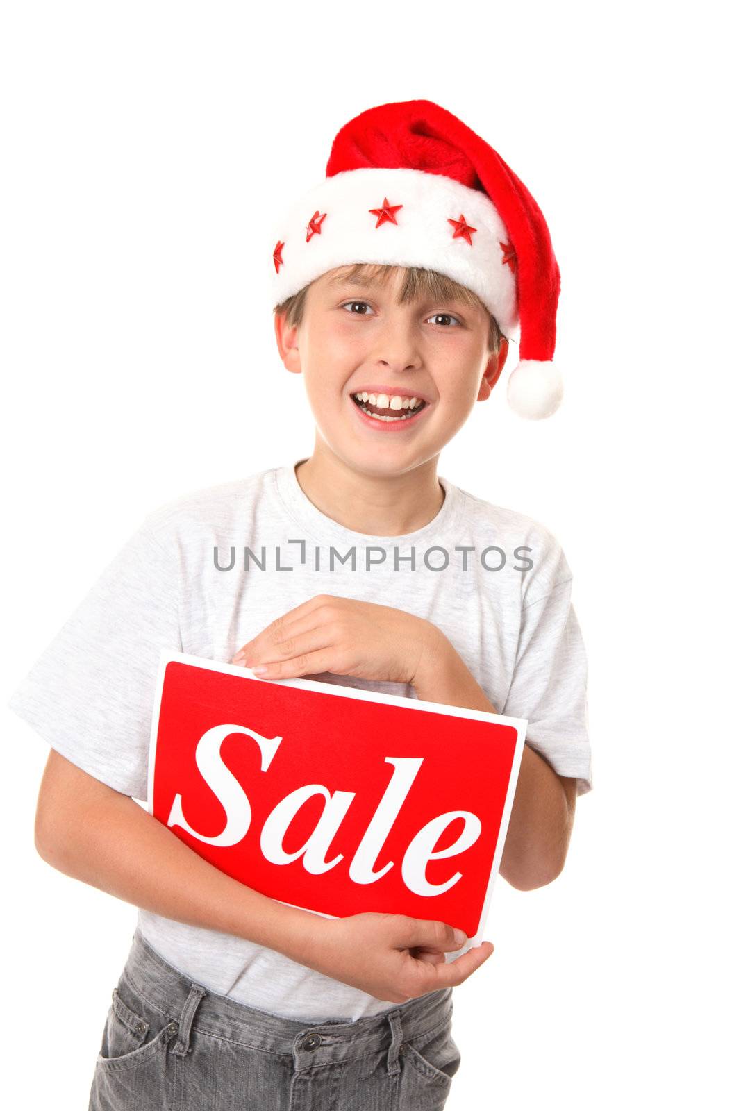 Smiling joyful child holding a Sale Sign - pre or post Christmas sales