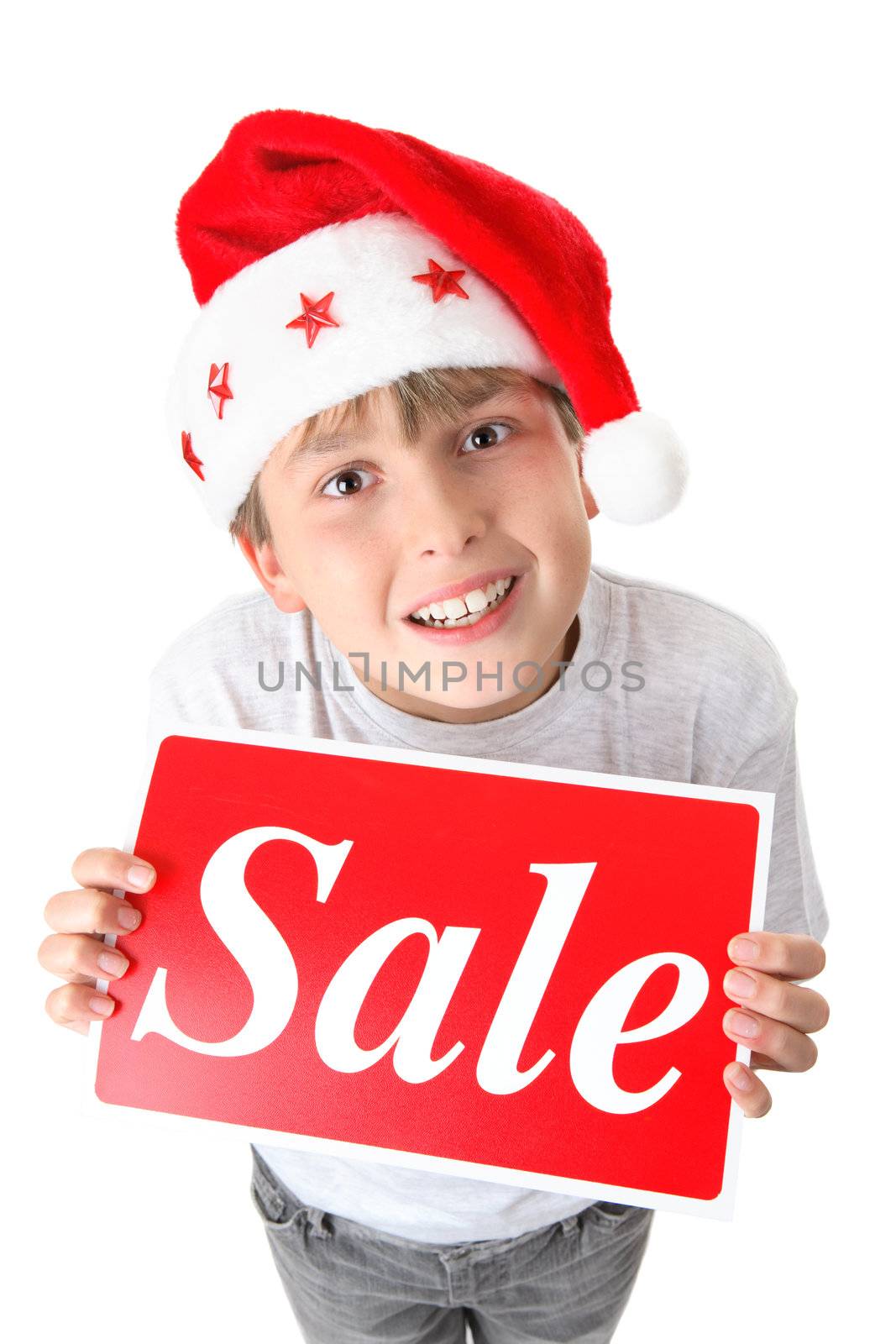 Child holding a retail sale sign and looking up.