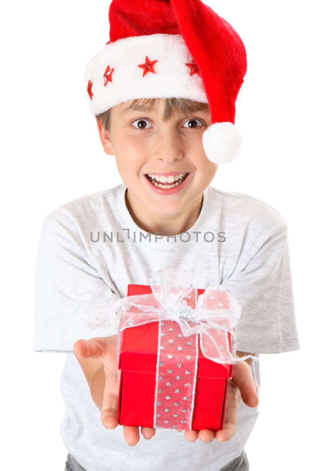 A festive child hands out a present at Christmas time.