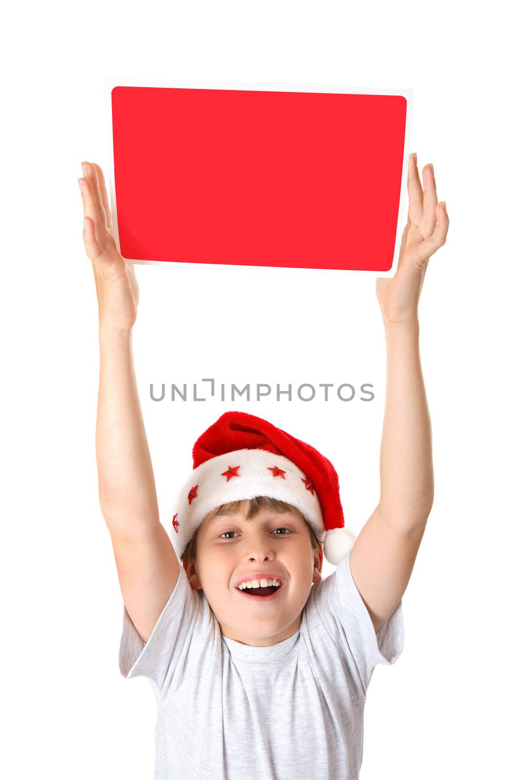 An exuberant boy holding up a Christmas Message or Sign