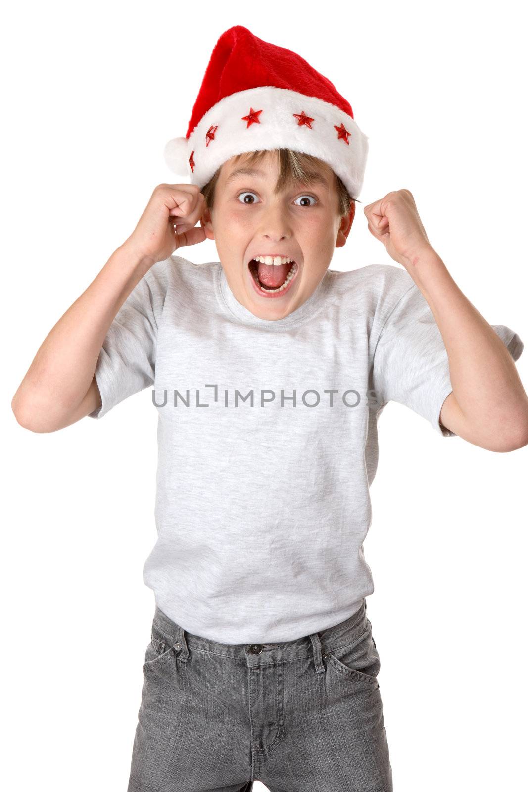 A child wearing a red santa hat jumps with glee and anticiapation.