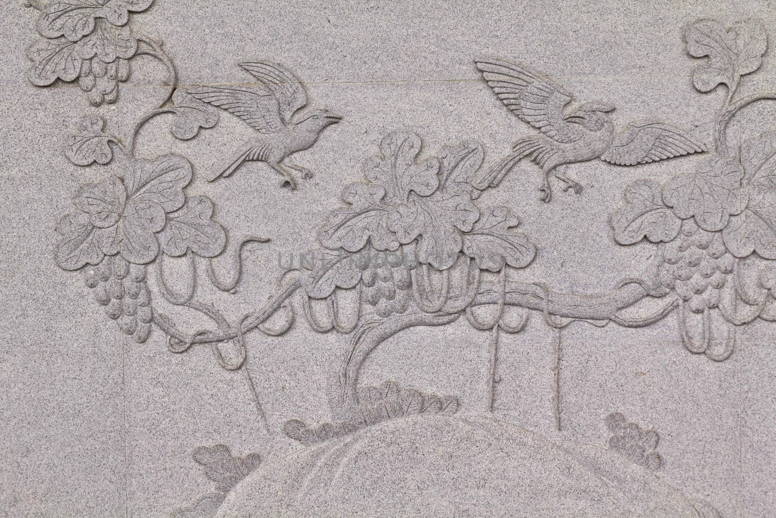Bird carved on stone wall in chinese temple Thailand by lavoview