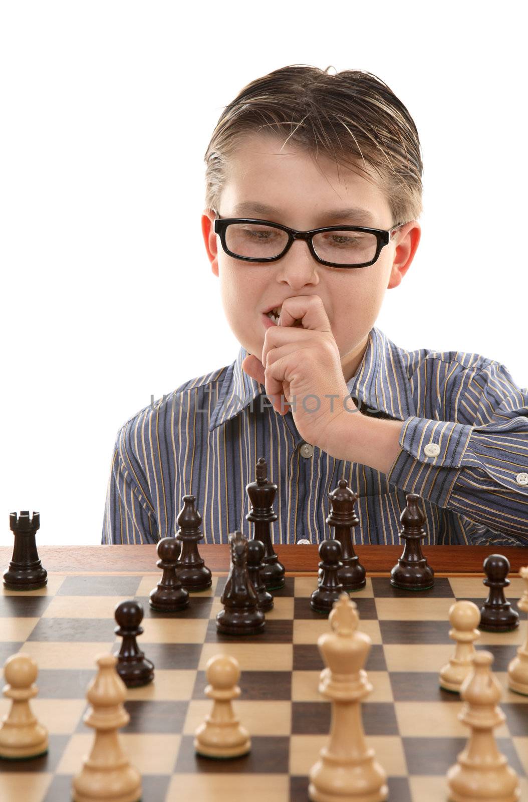 A young chess player contemplates a game plan or strategic move.  Skillful chess players look between 3 and 5 moves ahead. 