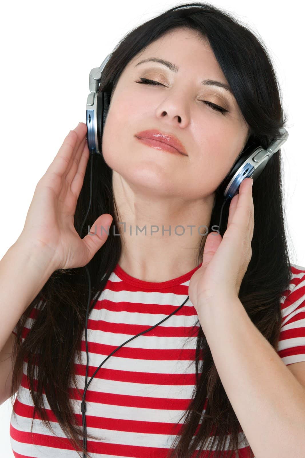 A casual dressed woman laid back listens quietly to some music