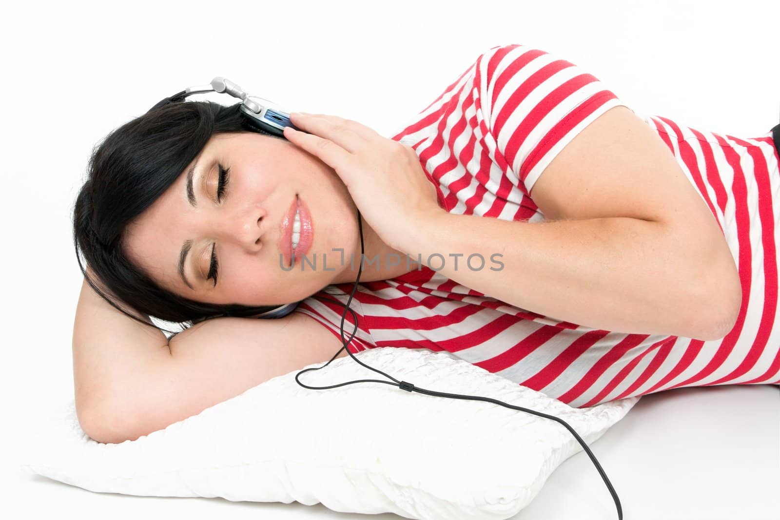 A woman at leisure relaxes to some music