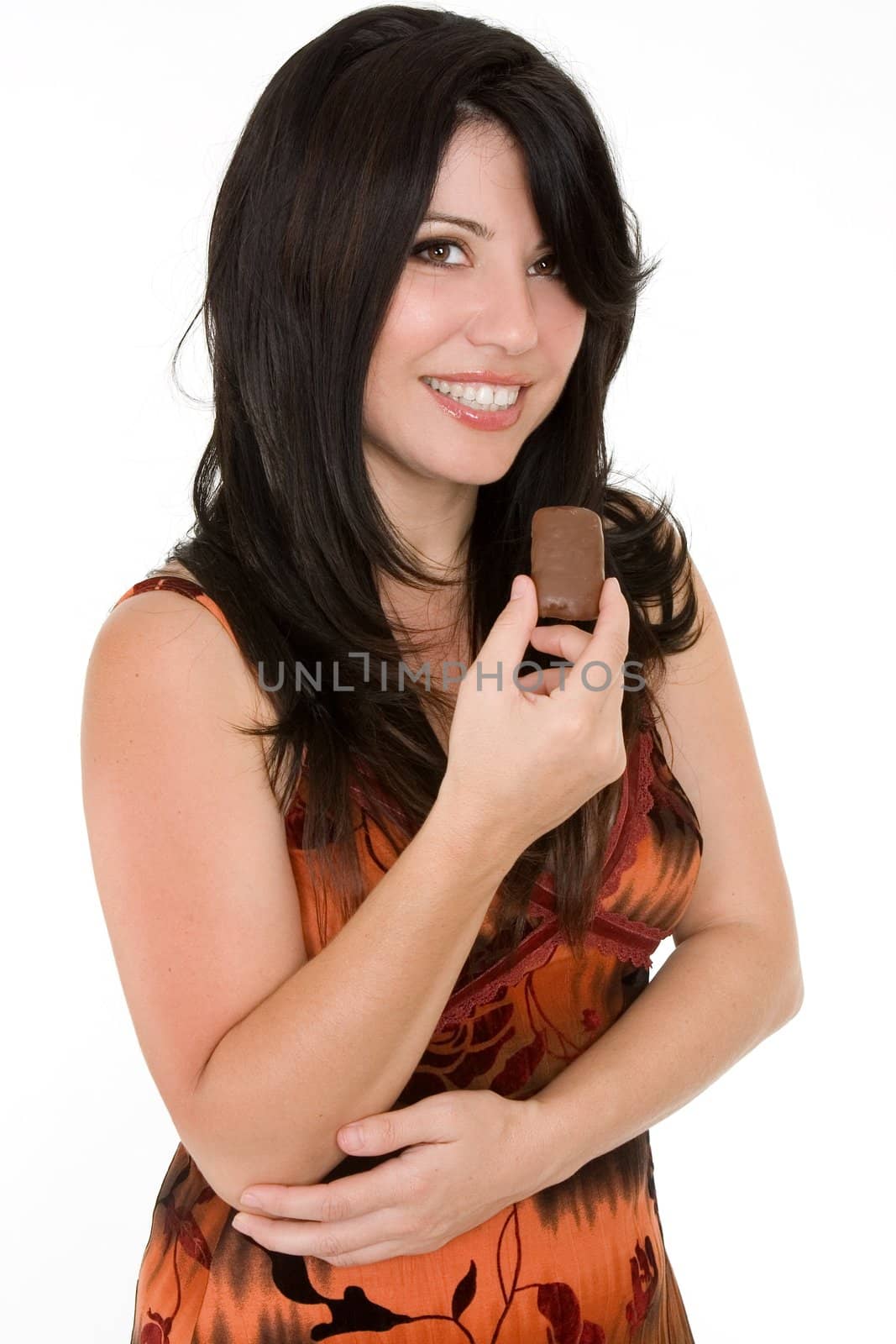 Woman in summer dress enjoying a chocolate snack in moderation.