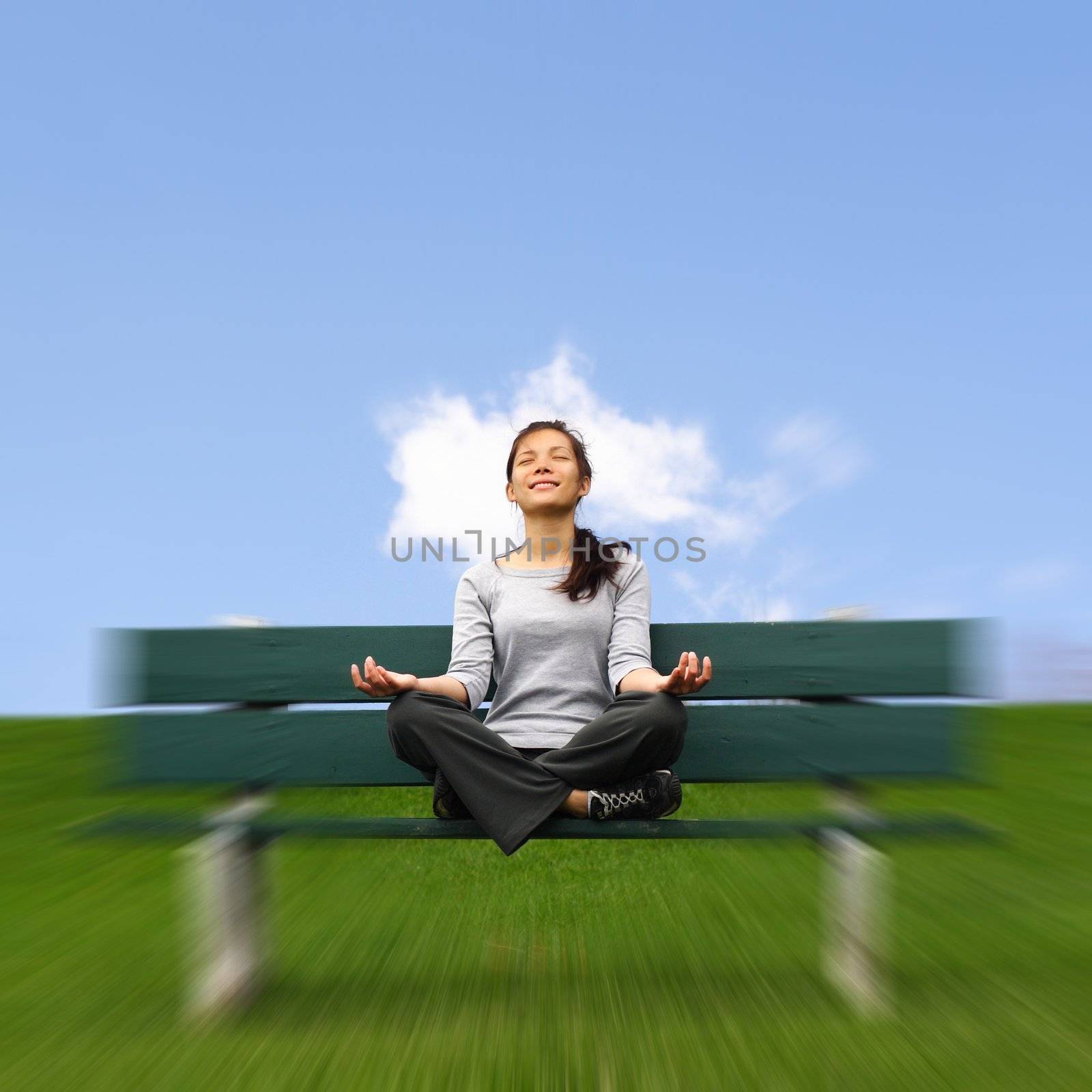 Meditation outdoors. Beautiful mixed asian / caucasian woman. With copy space.