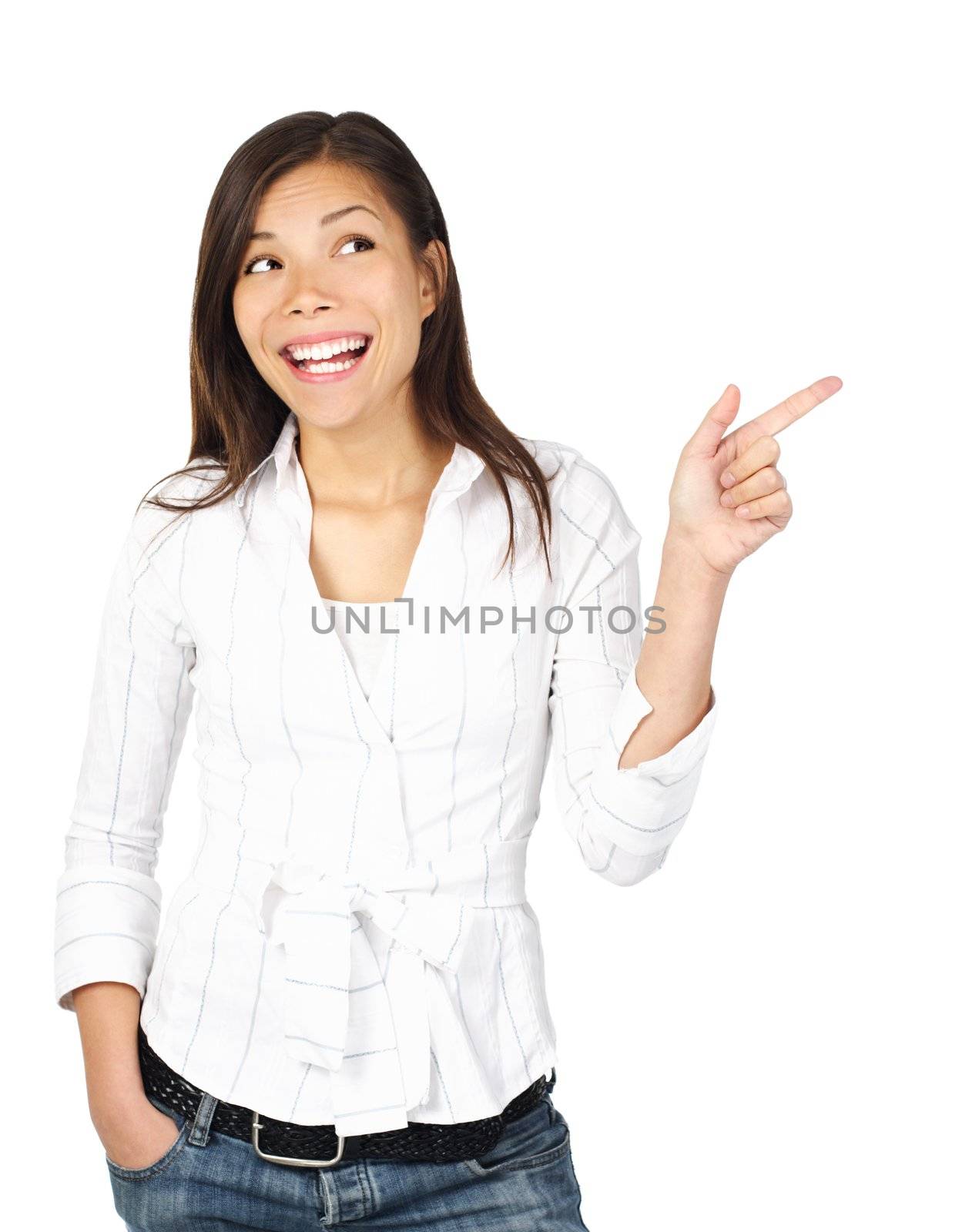 Woman pointing and looking to the side. Casual beautiful young mixed asian / caucasian woman happy and smiling. Isolated on white background.