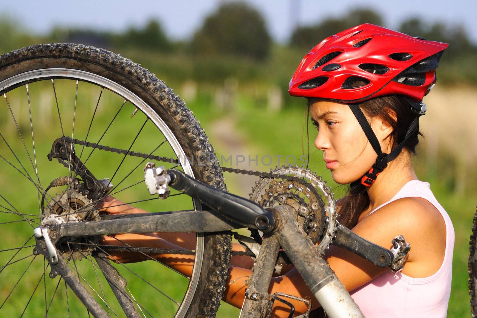 Bike repair. Woman repairing mountain bike.