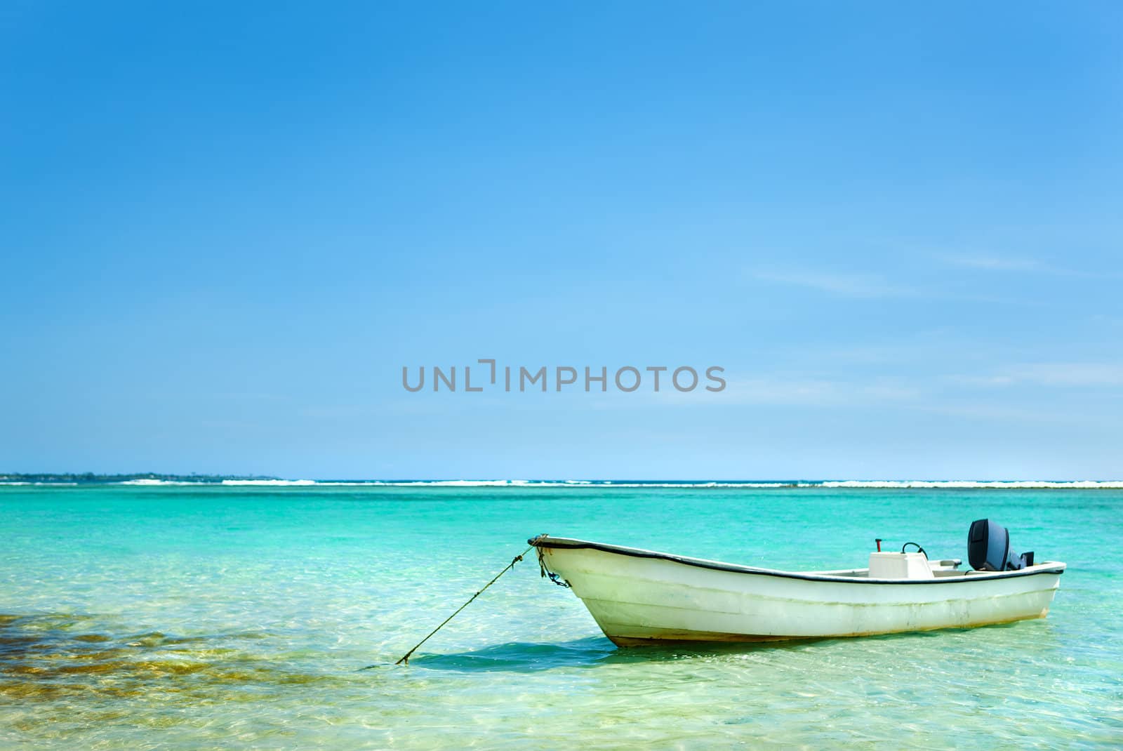 Sailbote anchored in Caribbean sea on a summer day