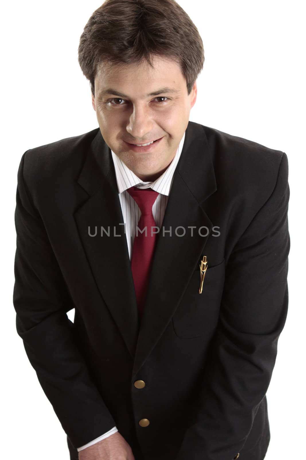 Businessman or salesman in a black suit looks up and smiles cheerfully.