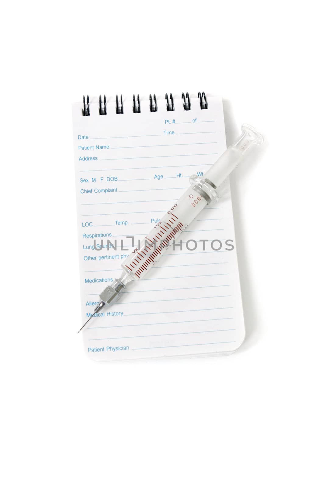 A medical notebook used my doctors and emergency services personnel and syringe needle on a white background.