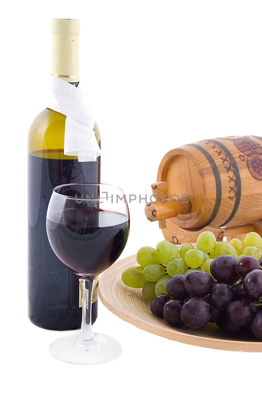 Red wine bottle, glass and cask with grapes over white