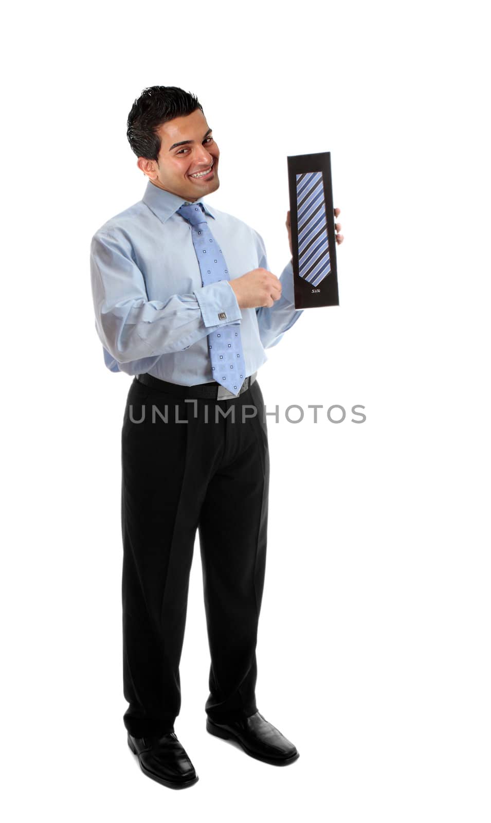 A salesman holding or presenting a mens silk tie or other boxed product.  White background.