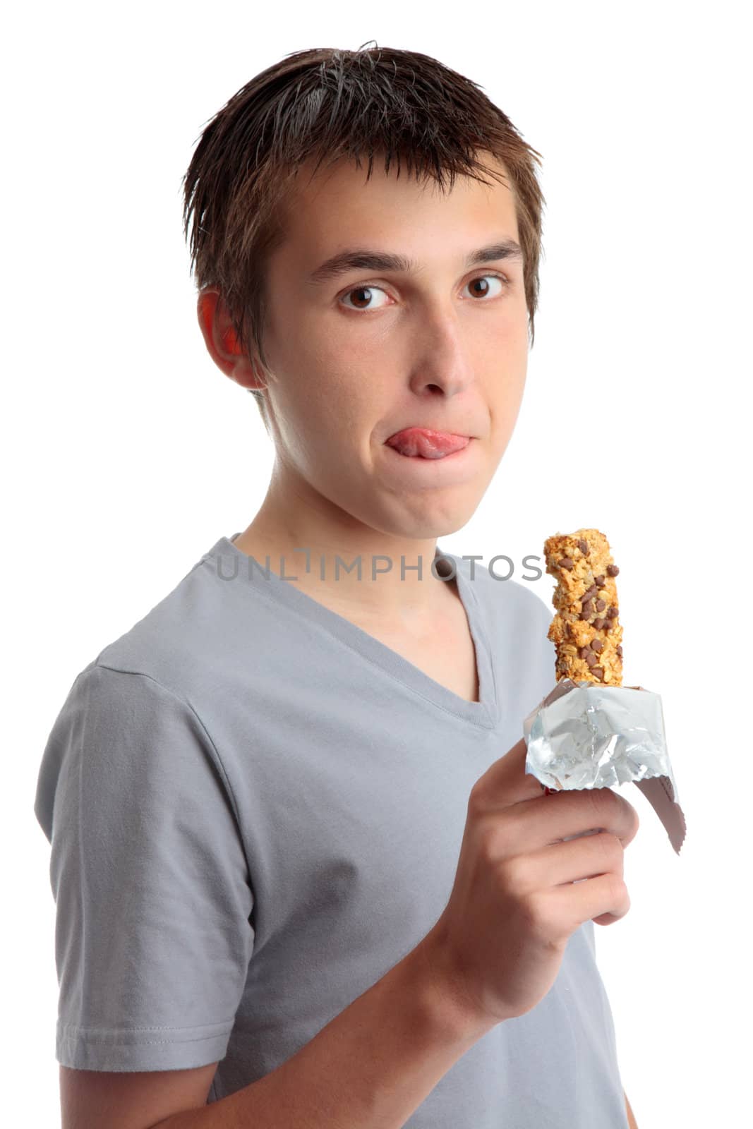 Nutrition.  A boy enjoys a delicious healthy muesli snack bar