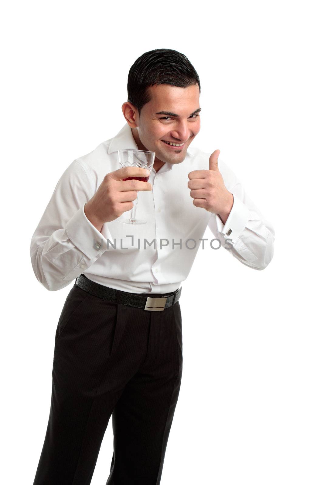A happy, laughing and optimistic man holding a glass of red wine and showing thumbs up success or approval hand sign.