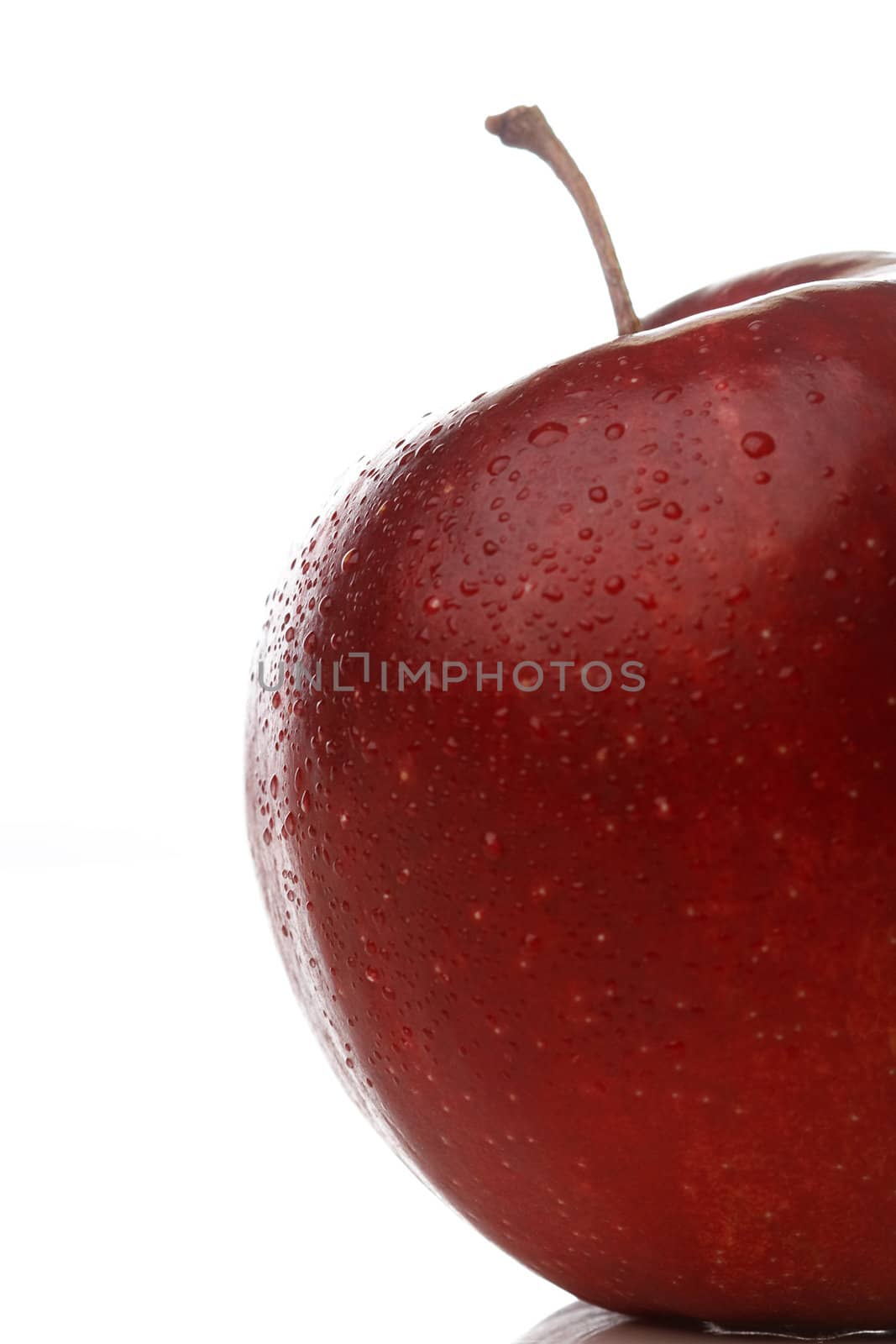 A red apple with waterdrops isolated on white background