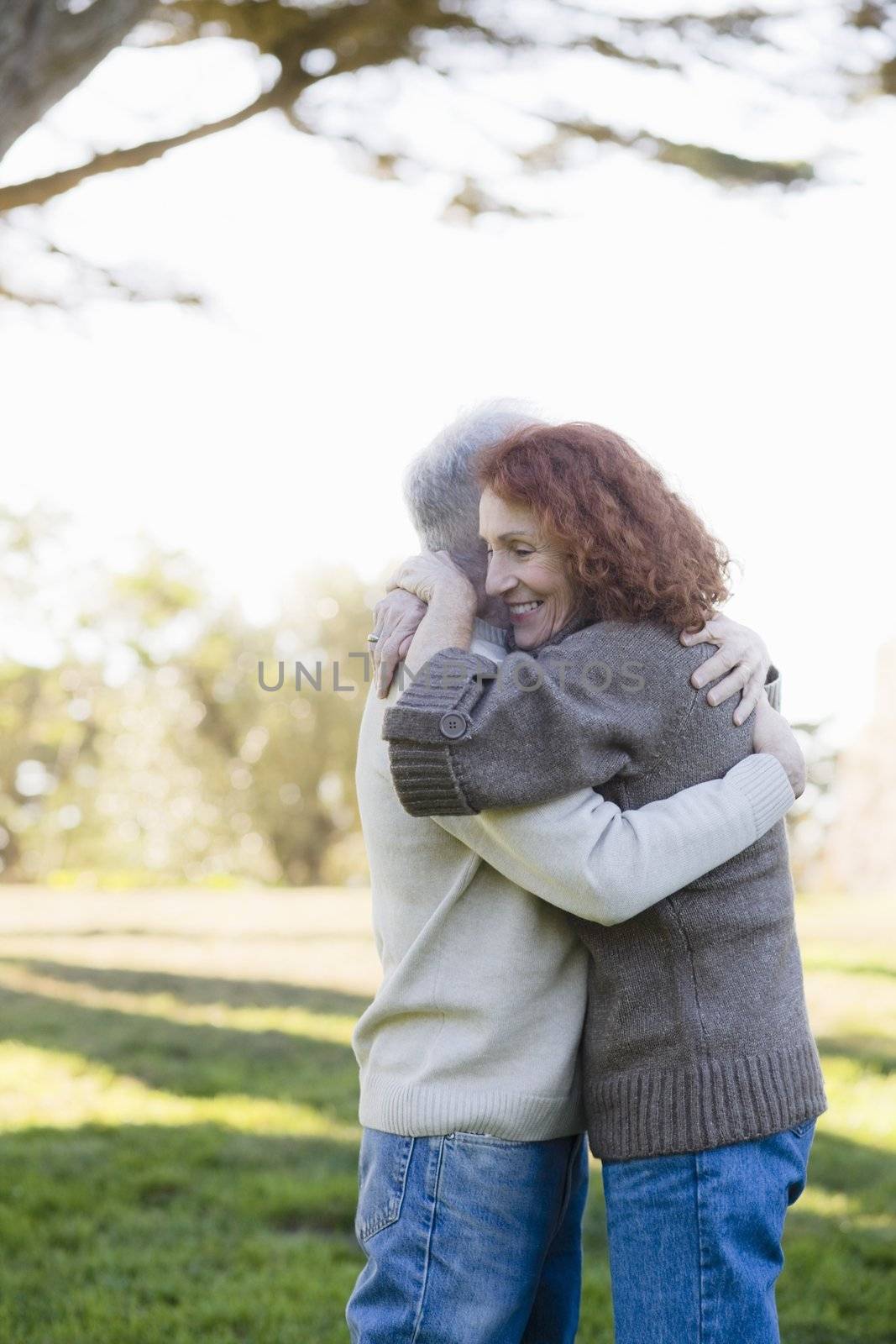 Smiling Senior Couple Hugging Each Other in a Park