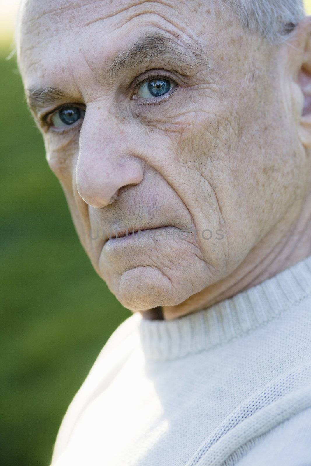 Portrait of a Serious Old Man Looking Directly To Camera