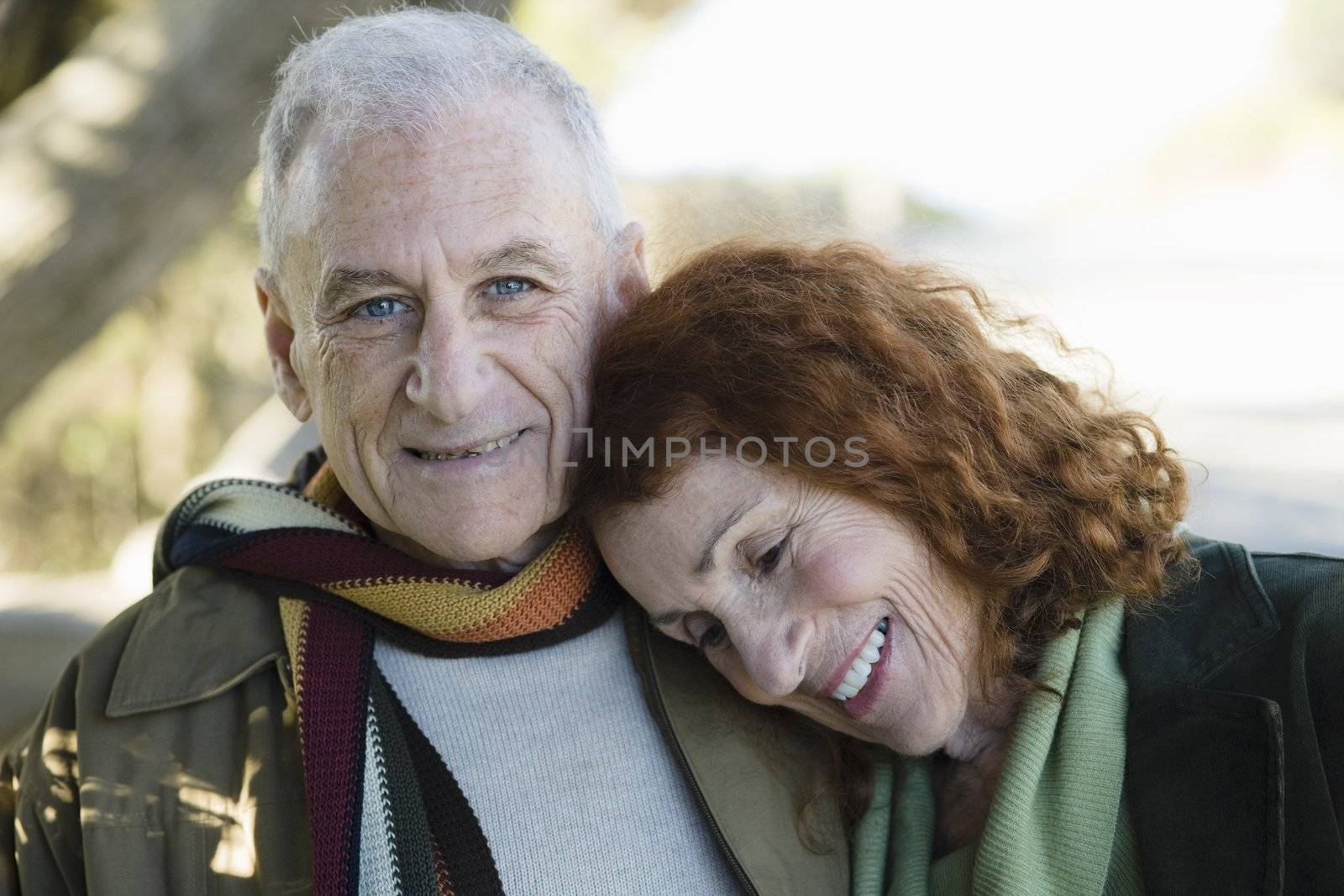 Smiling Senior Couple Standing Outside in a Park