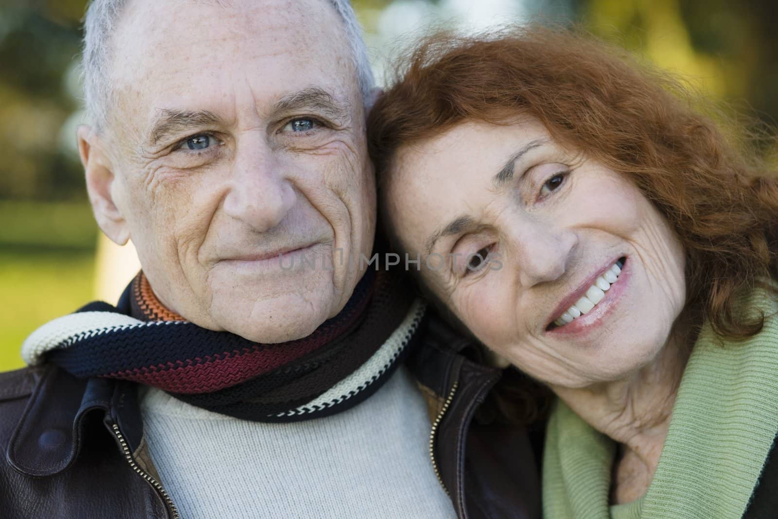 Portrait of Two Happy Seniors Leaning on Each Other