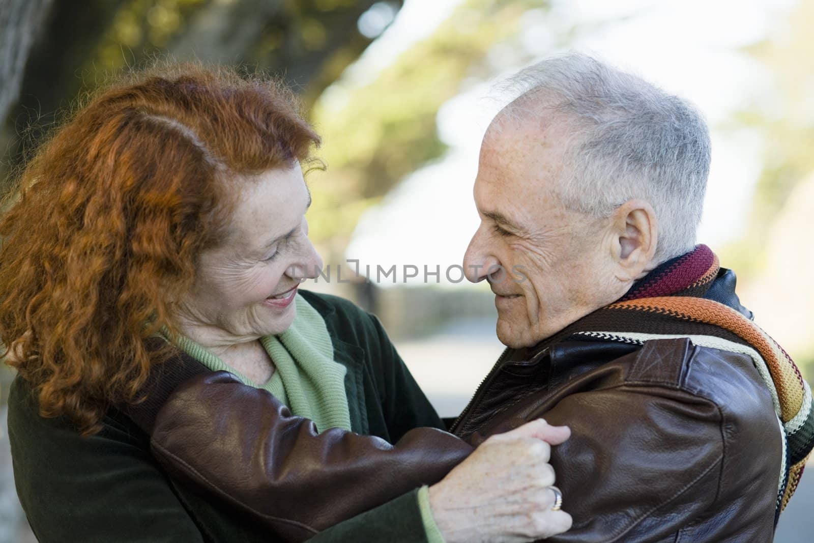 Portrait of Two Happy Seniors Smiling at Each Other