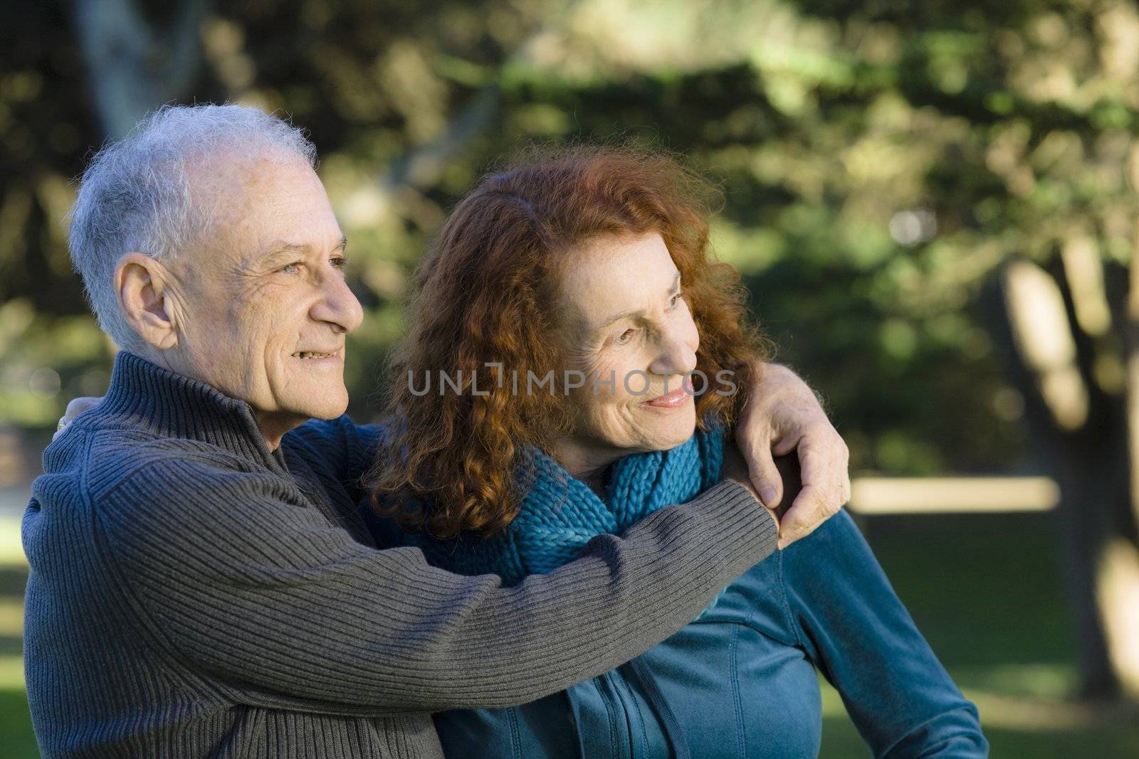 Smiling Senior Couple Holding Each Other in a Park