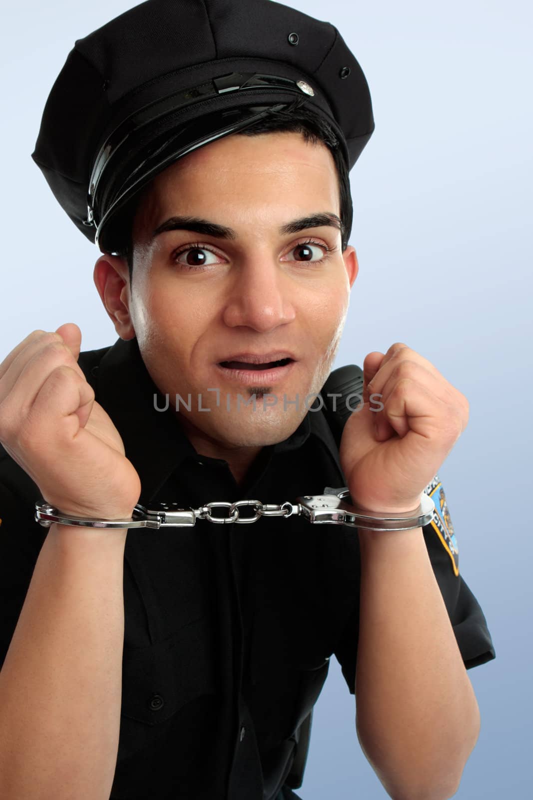 Crazy policeman with hands in handcuffs arrest.