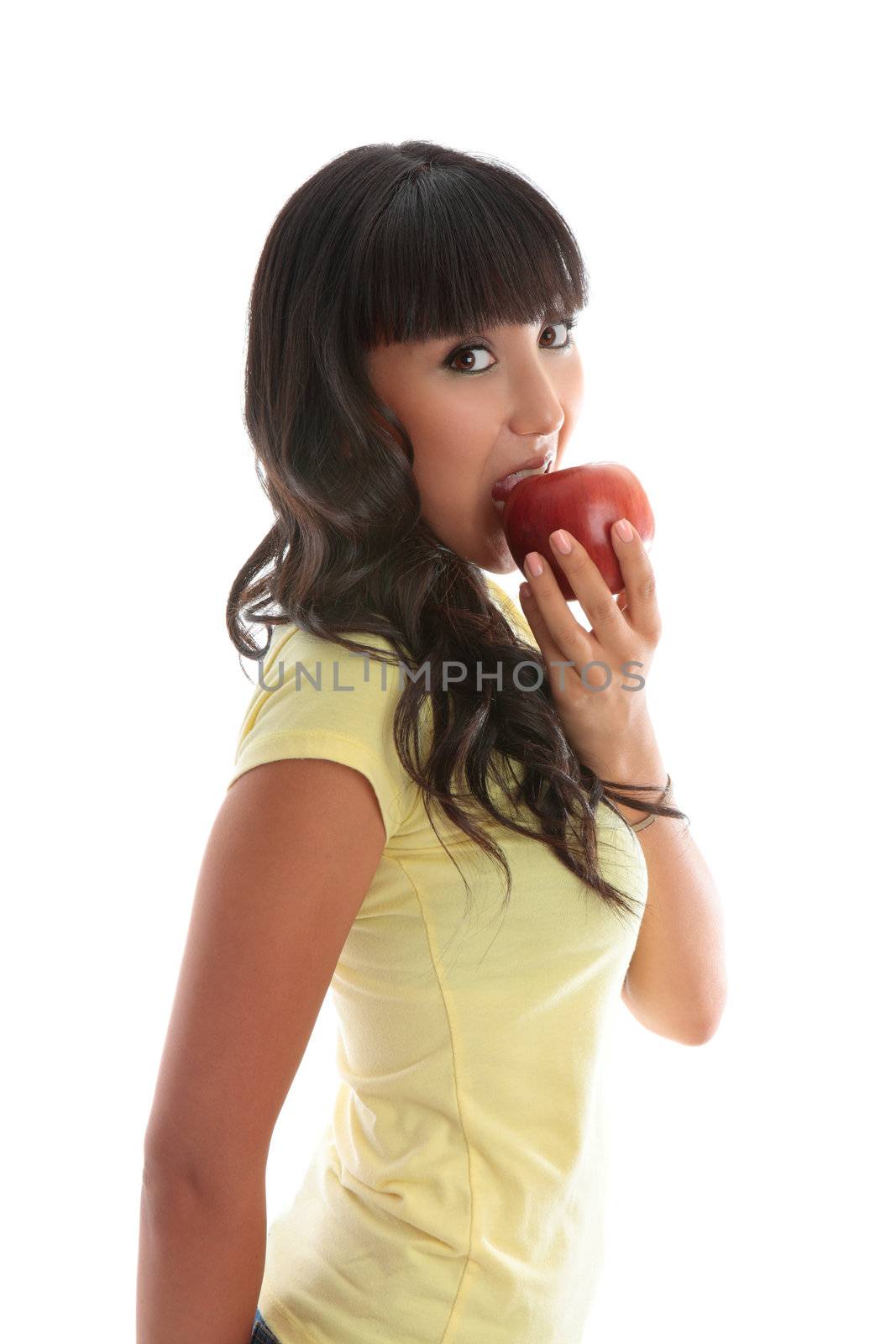A pretty healthy girl bites into a healthy snack alternative - juicy red apple.