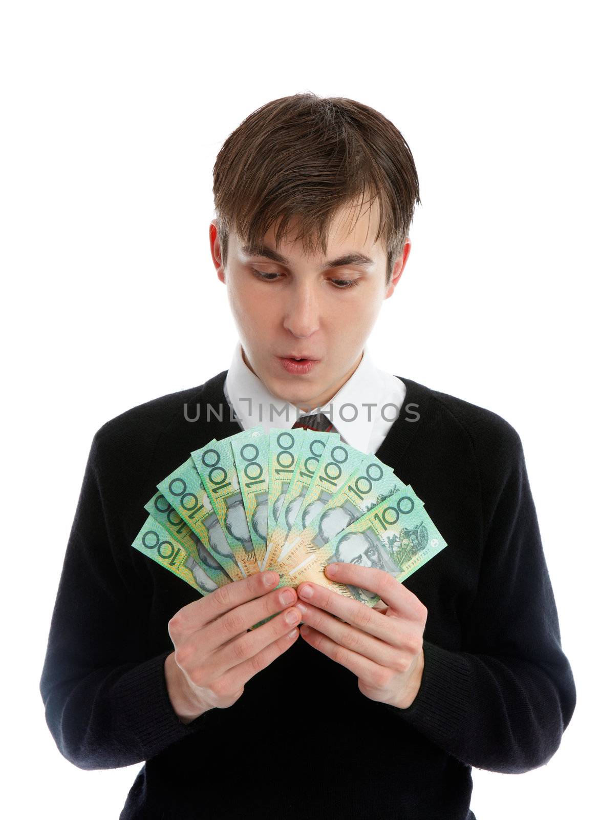 A student or young worker looking with great amazement at a fan of banknotes in his hand.  Concept shcolarship, fundraising, fees, winnings, wages, etc.    NB: less than 1/2 note in view. (http://www.secretservice.gov/money_illustrations.shtml)