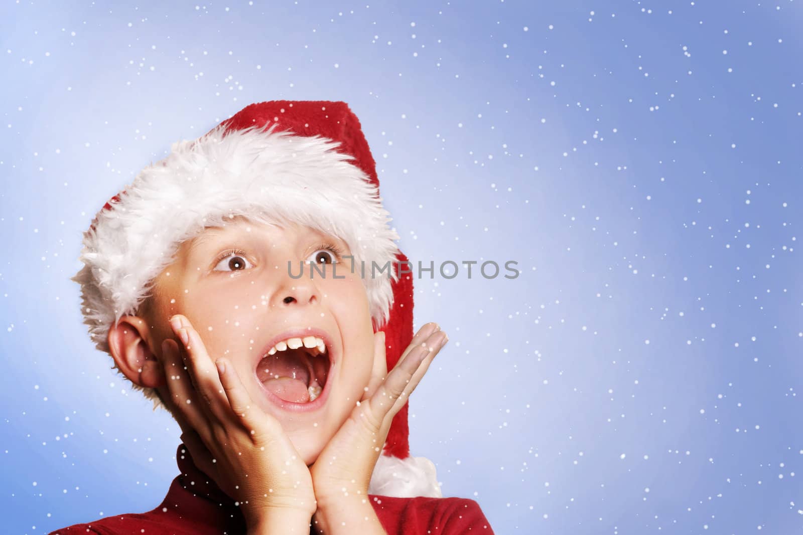 Excited young boy amongst snowflakes.