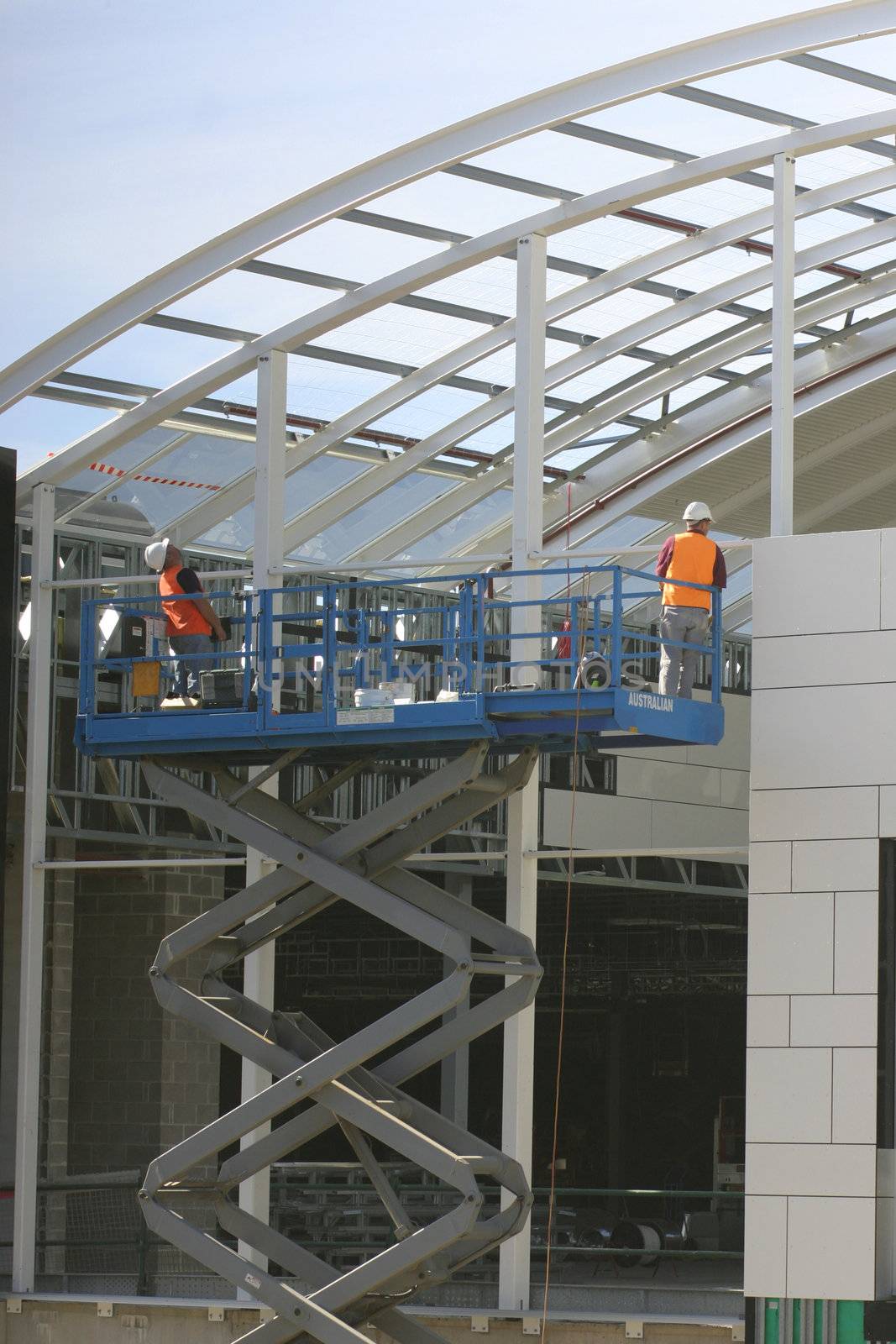 Two workman on a platform
