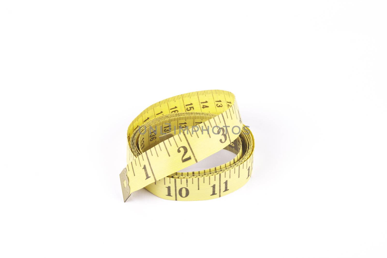 Yellow curled tape measure with a reflective white background