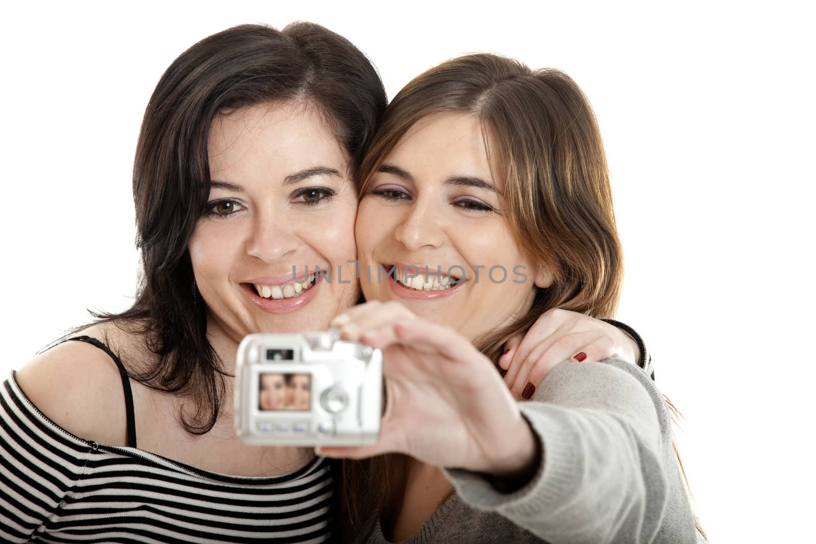 Two beautiful young woman taking self portraits