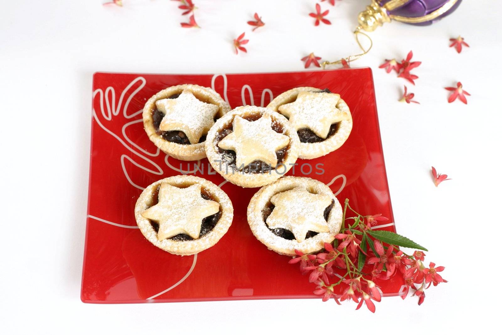 Christmas tarts on a decorative plate with ornamental Australian Christmas bush flowers.