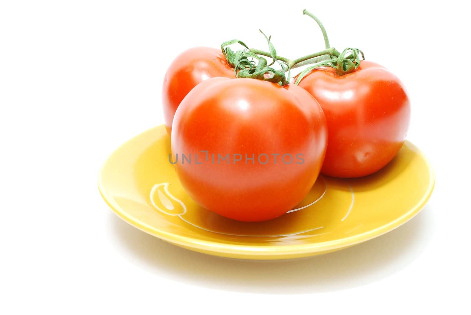 Three Red Tomatoes on Yellow Plate Isolated on White