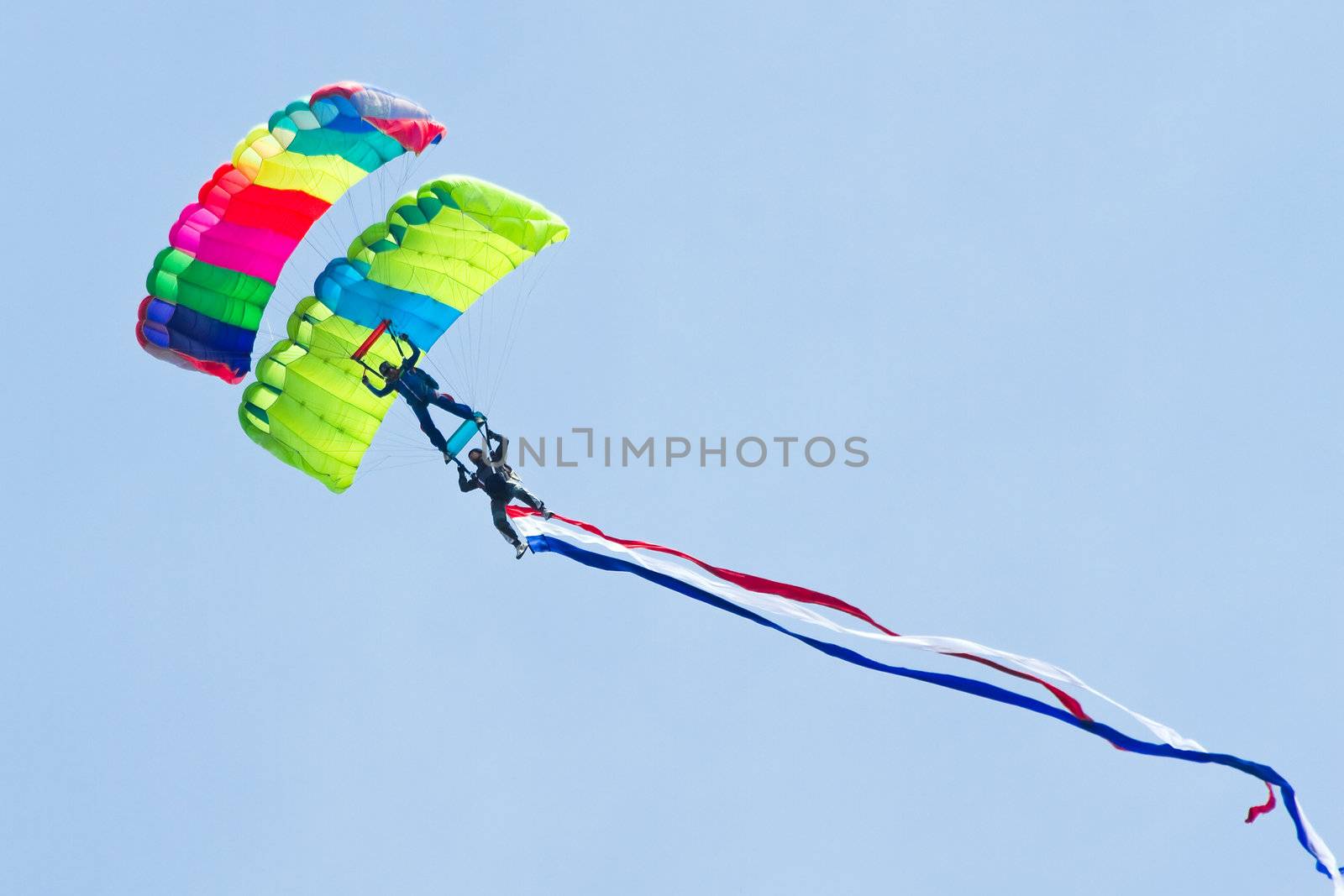 Parachutists demonstrate jumping from airplane by Colette