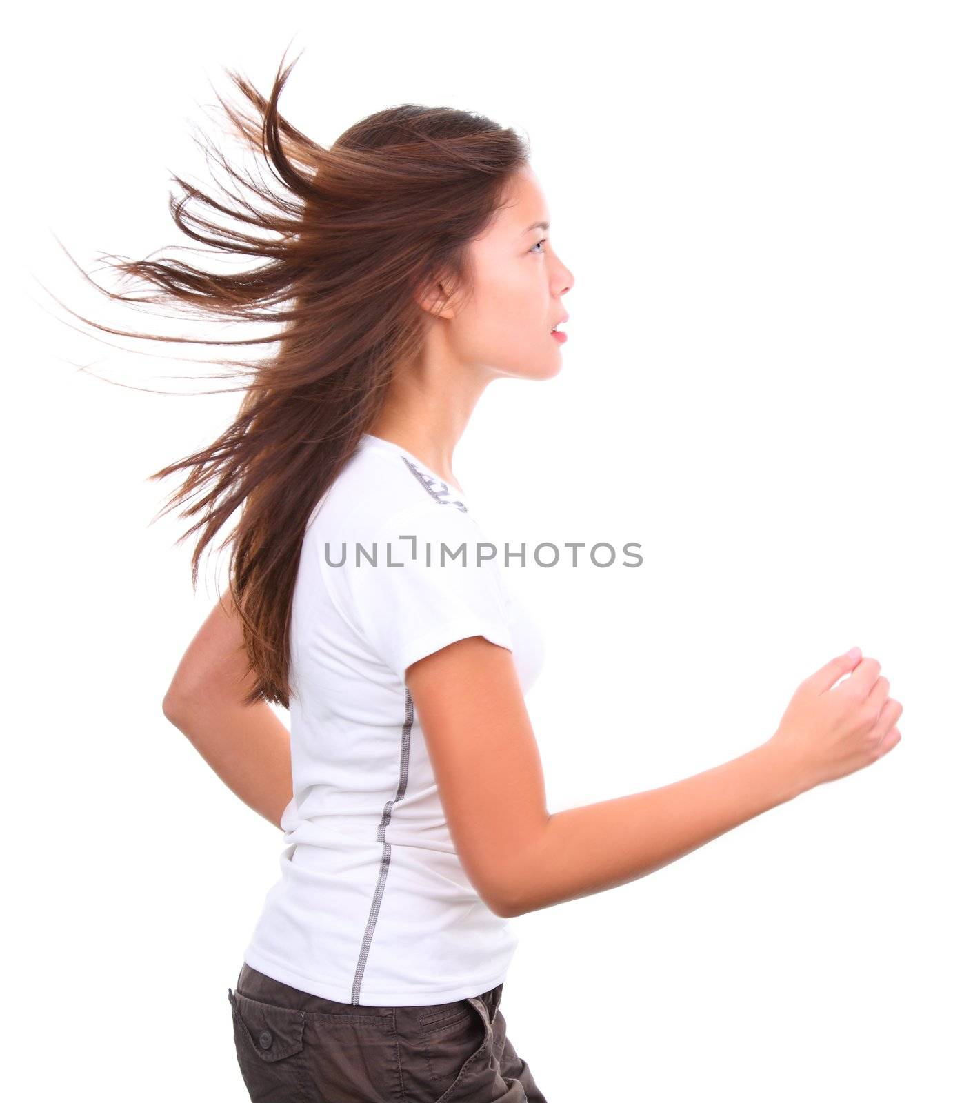 Isolated girl running with hair flying in the wind. Studio shot.