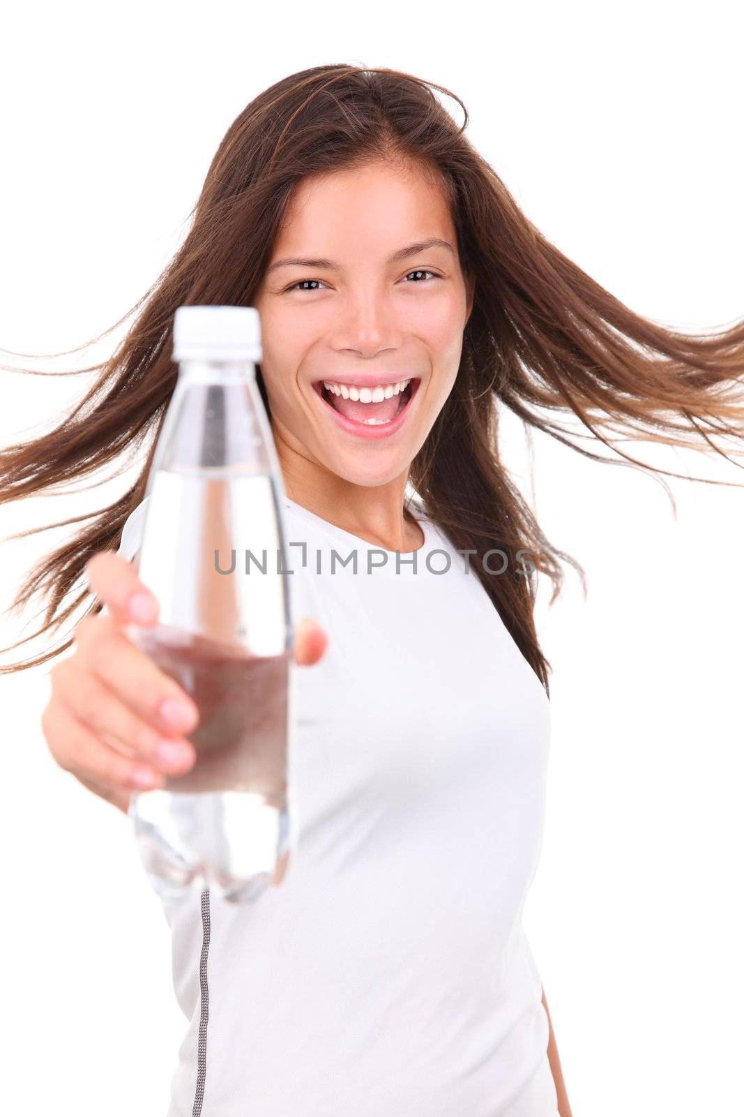 Excited young woman showing a bottle of water after doing sport. Isolated on white background.