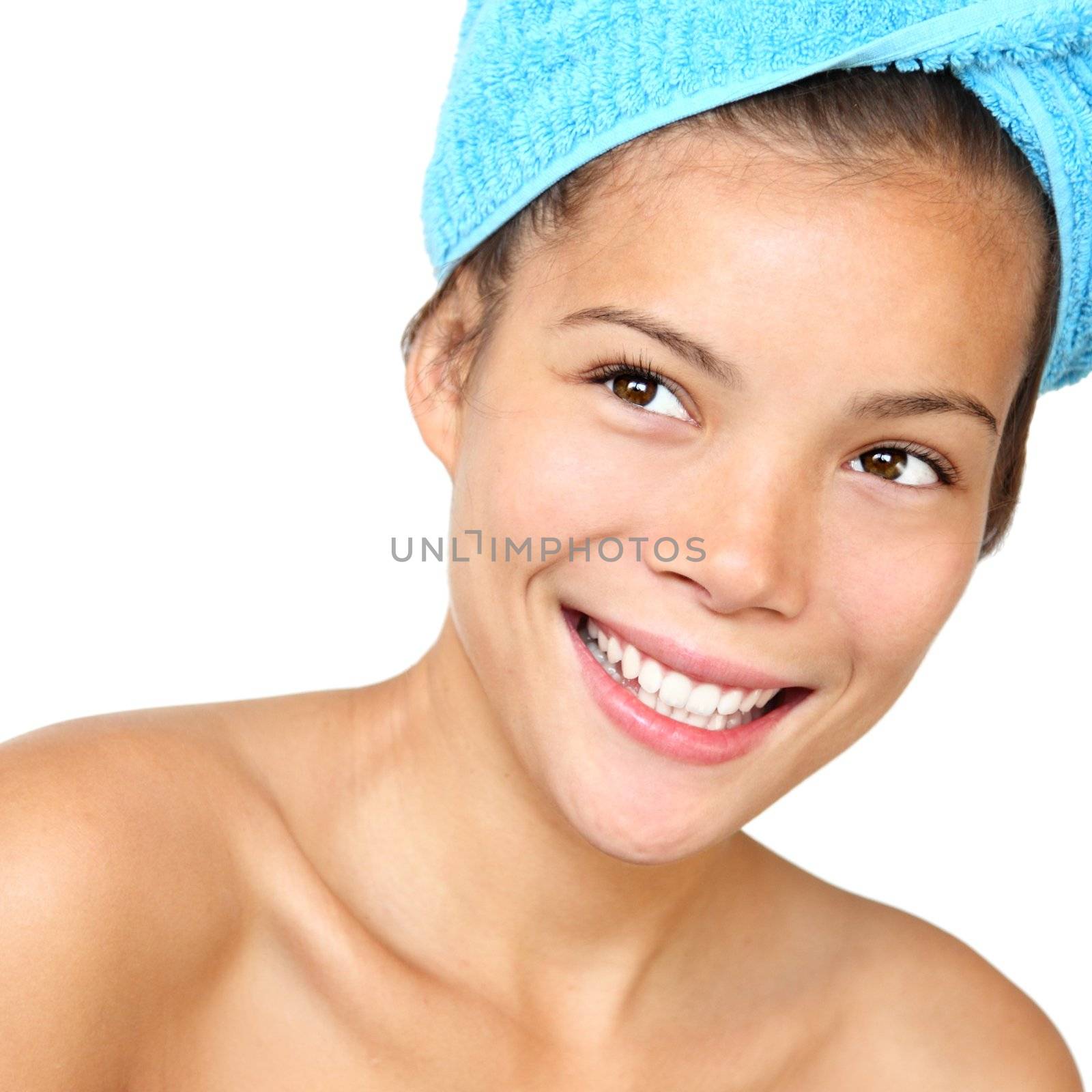 Towel and shower beauty.Smiling healthy looking woman with towels just out of the shower. Beautiful mixed asian / caucasian young woman model. Isolated on white background.